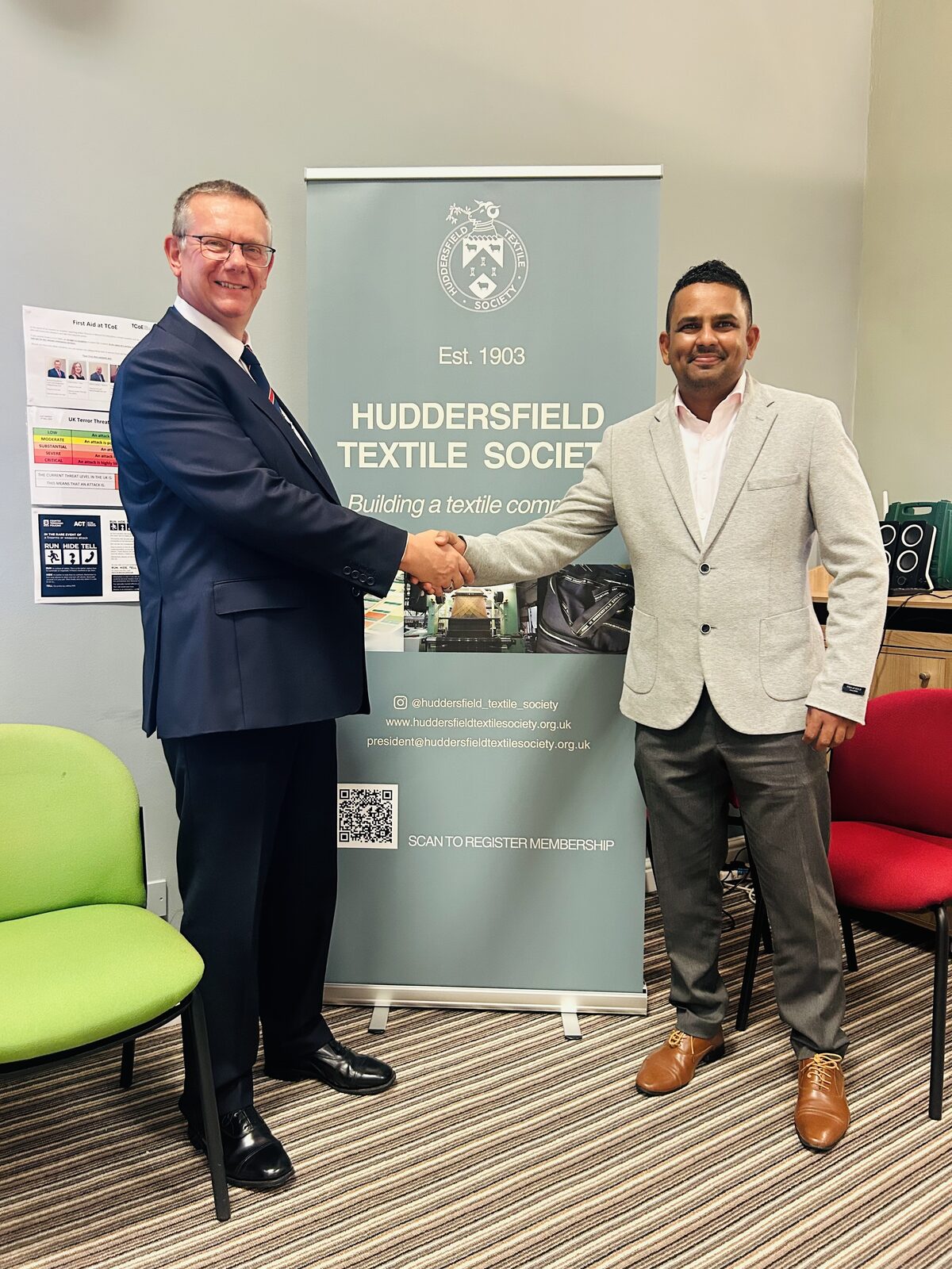 Paul Mendis shaking hands with Huddersfield Textile Society leadership at the HTS AGM